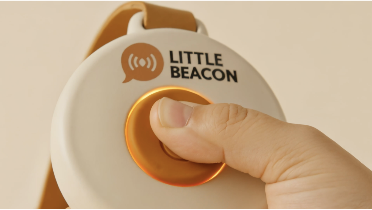 Child pressing the Little Beacon button